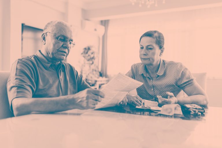 Two serious mature adults looking at post.