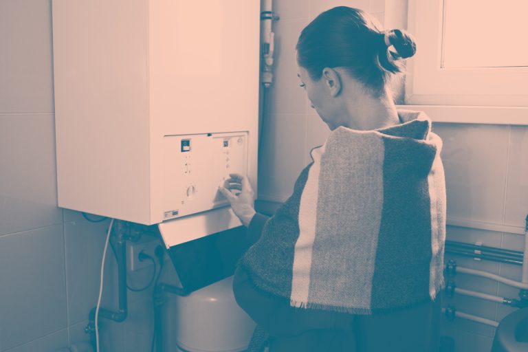 An adult woman using a boiler.