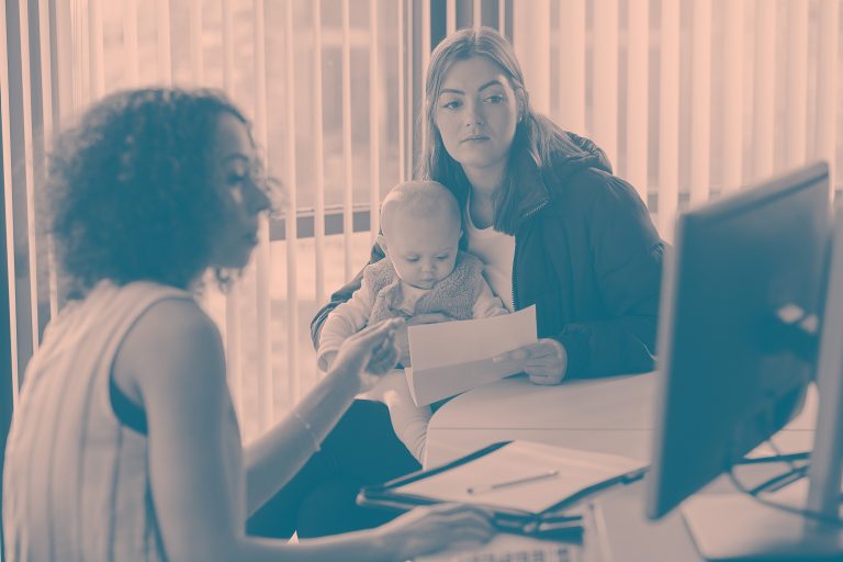 An adult woman getting advice with baby.
